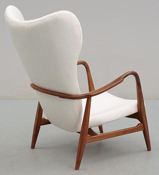 A Danish upholstered wing-back armchair, 1940-50's,