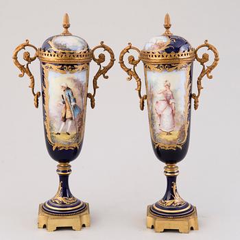 Pair of Sevres Chateau des Tuileries porcelain lidded urns, mid-19th century.