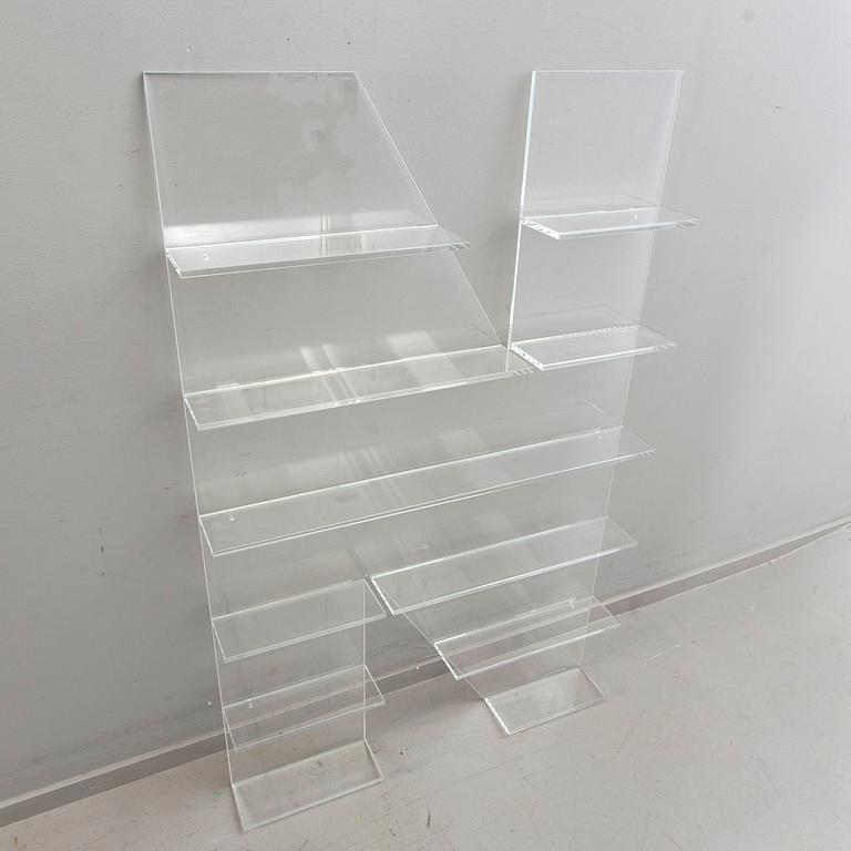 Shelf, plexi glass, in the shape of the letter 'N', Non Violence.