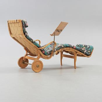 A Bruno Mathsson Swedish Modern chair with attached reading table, Karl Mathsson, Värnamo 1944.