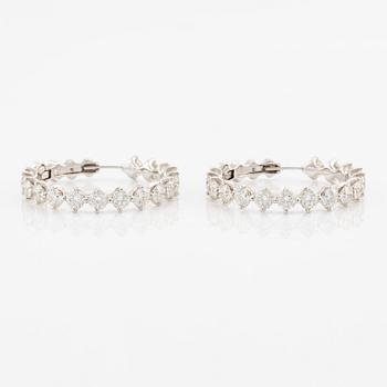 A pair of earrings in 18K white gold set with round brilliant-cut diamonds.