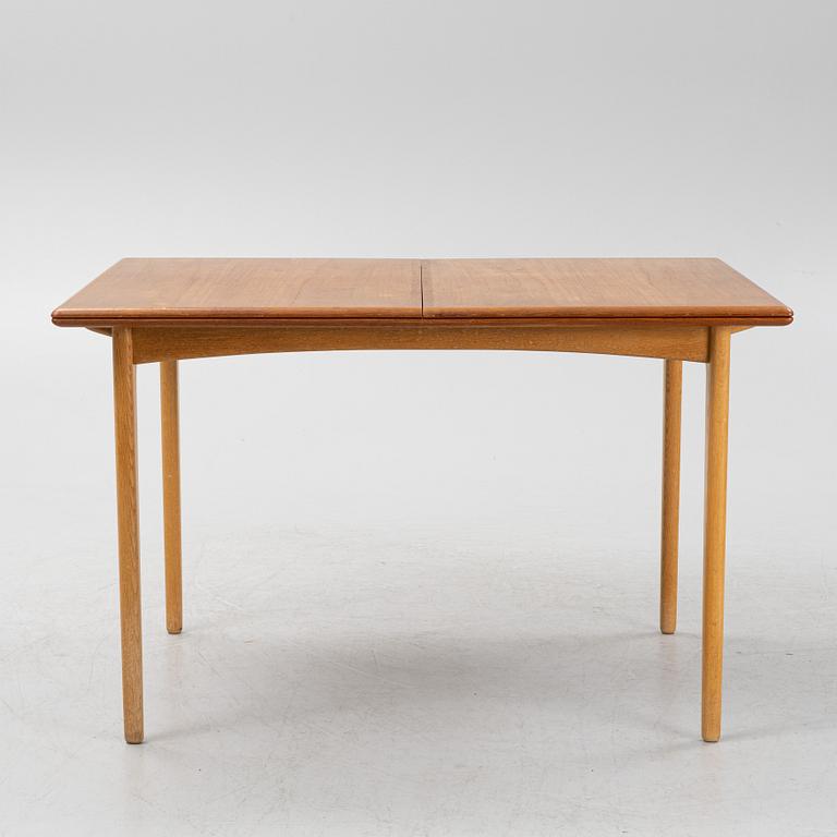 A 1960's teak and rosewood veneered dining table.