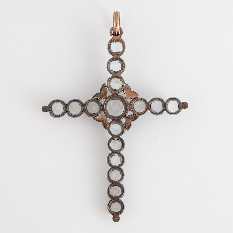 Cross pendant with silver and white stones.