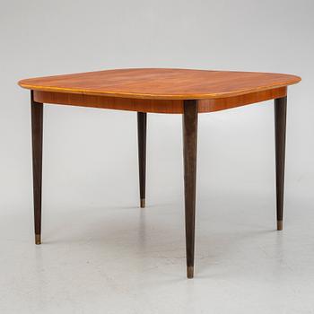 A teak-veneered dining table, mid 20th century.