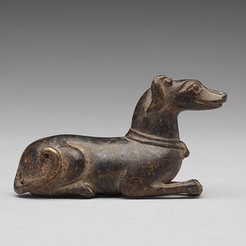 529. A bronze figure of a reclining dog, Ming dynasty (1368-1644).