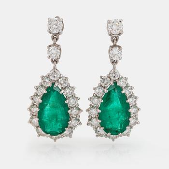 1091. A pair of drop shaped faceted emerald and round brilliant-cut diamond earrings in 18K white gold.