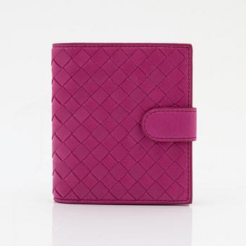 Bottega Veneta, a cerise leather wallet.