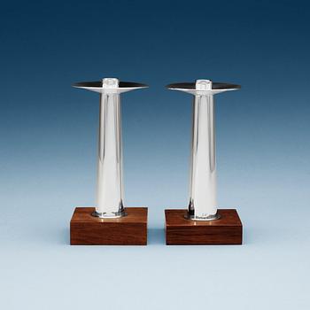 509. A pair of Finnish silver candlesticks on a teak base, Kultakeskus OY, Tavastehus, Finland 1963.