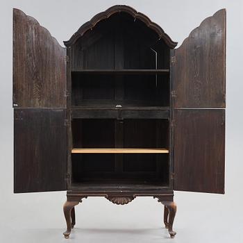 Tor Hörlin, a Swedish Grace decorated oak cabinet, dated 1920.