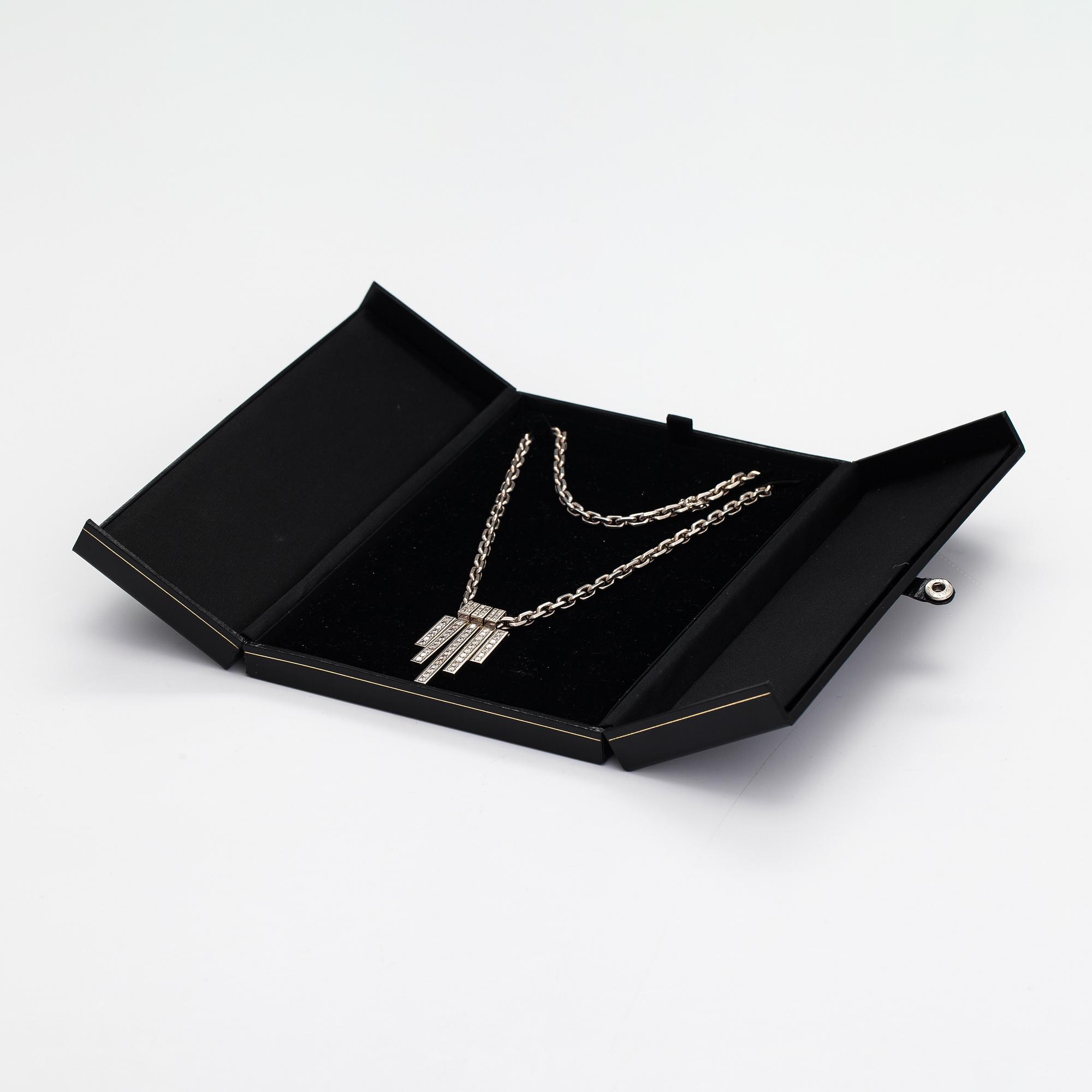 A pair of earrings and a necklace made of 14K white gold with diamonds ca. 4.50 ct in total. JB-Koru Tmi, Espoo 2005.