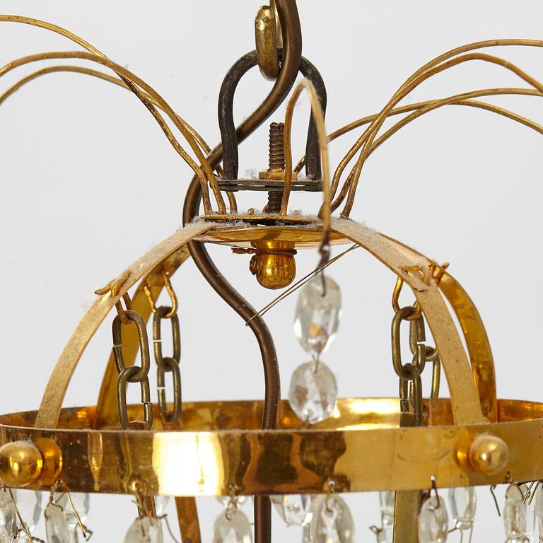 A late Gustavian gilt-brass and cut-glass four-branch chandelier, circa 1800.