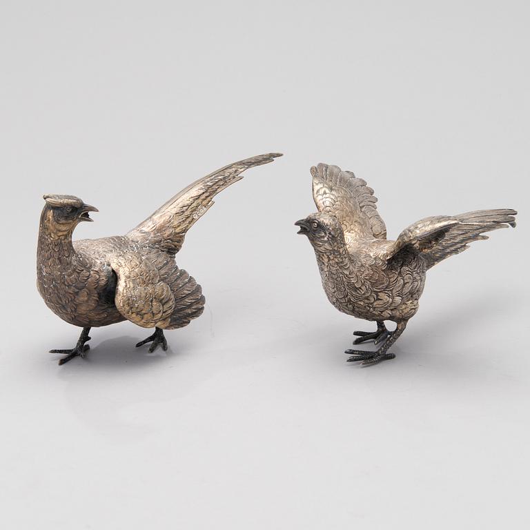 Two bird table decorations in silver, German and British hallmarks.