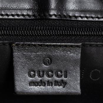 GUCCI, a leather and canvas bag.