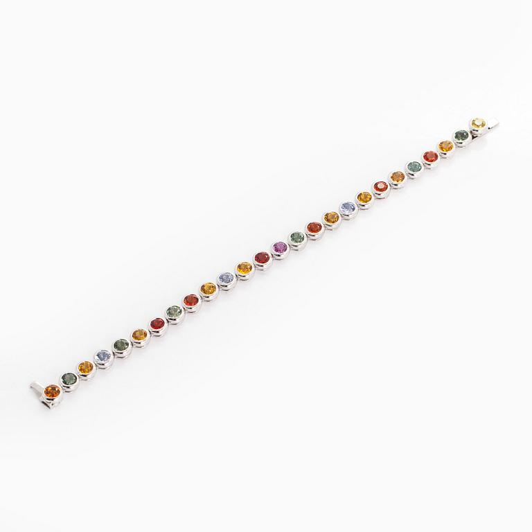 An 18K white gold bracelet, set with multicoloured sapphires.