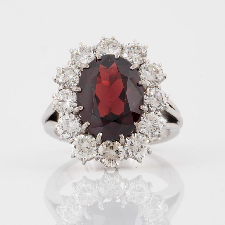 A garnet and brilliant-cut diamond ring.