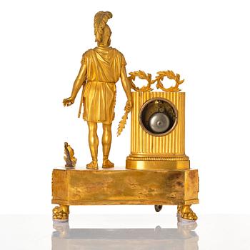 An Empire mantel clock, first part of the 19th century .