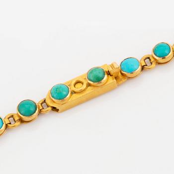 An 18K gold and turquoise cross with a chain and a 14K gold bracelet set with turquoises.