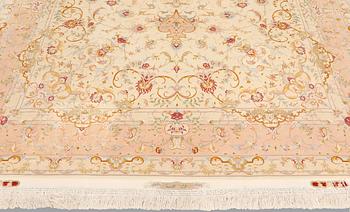 A Tabriz part silk carpet, signed, 305 x 203 cm.