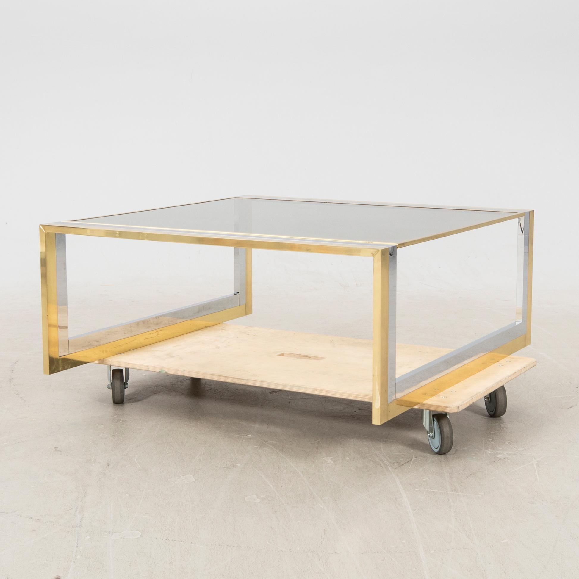 A glass and metal coffee table from Romeo Rega second half of the 20th century.