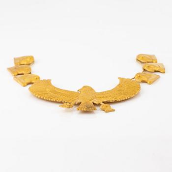 A modern Egyptian-style gold necklace.