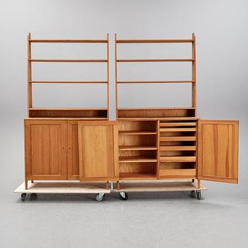 A pair of pine cupboards with shelves by Carl Malmsten.