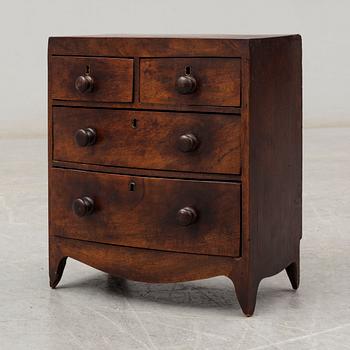 An early 19th Century Regency miniature chest of drawers.