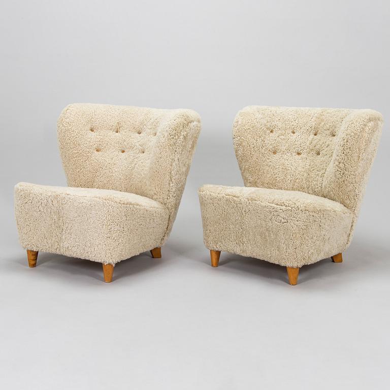 A pair of mid-20th century armchairs in sheepskin.