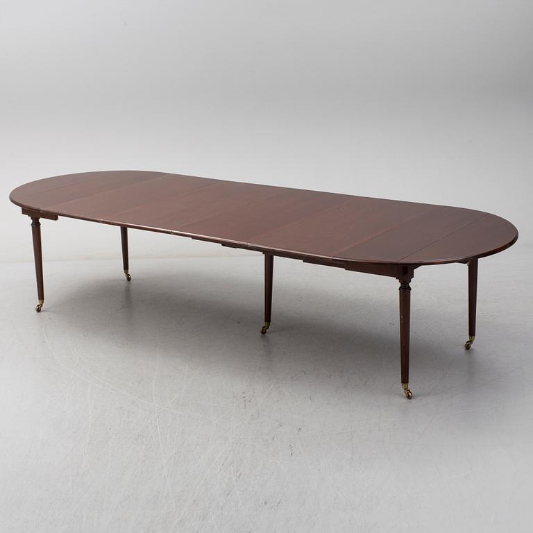 A mid 20th century mahogany veneered dining table by AB Harald Westerberg, Stockholm.