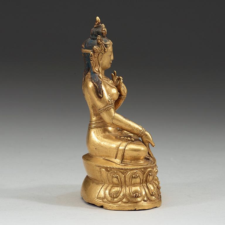 A partly gilt and painted Tibeto-Chinese bronze figure of White Tara, 18th Century.