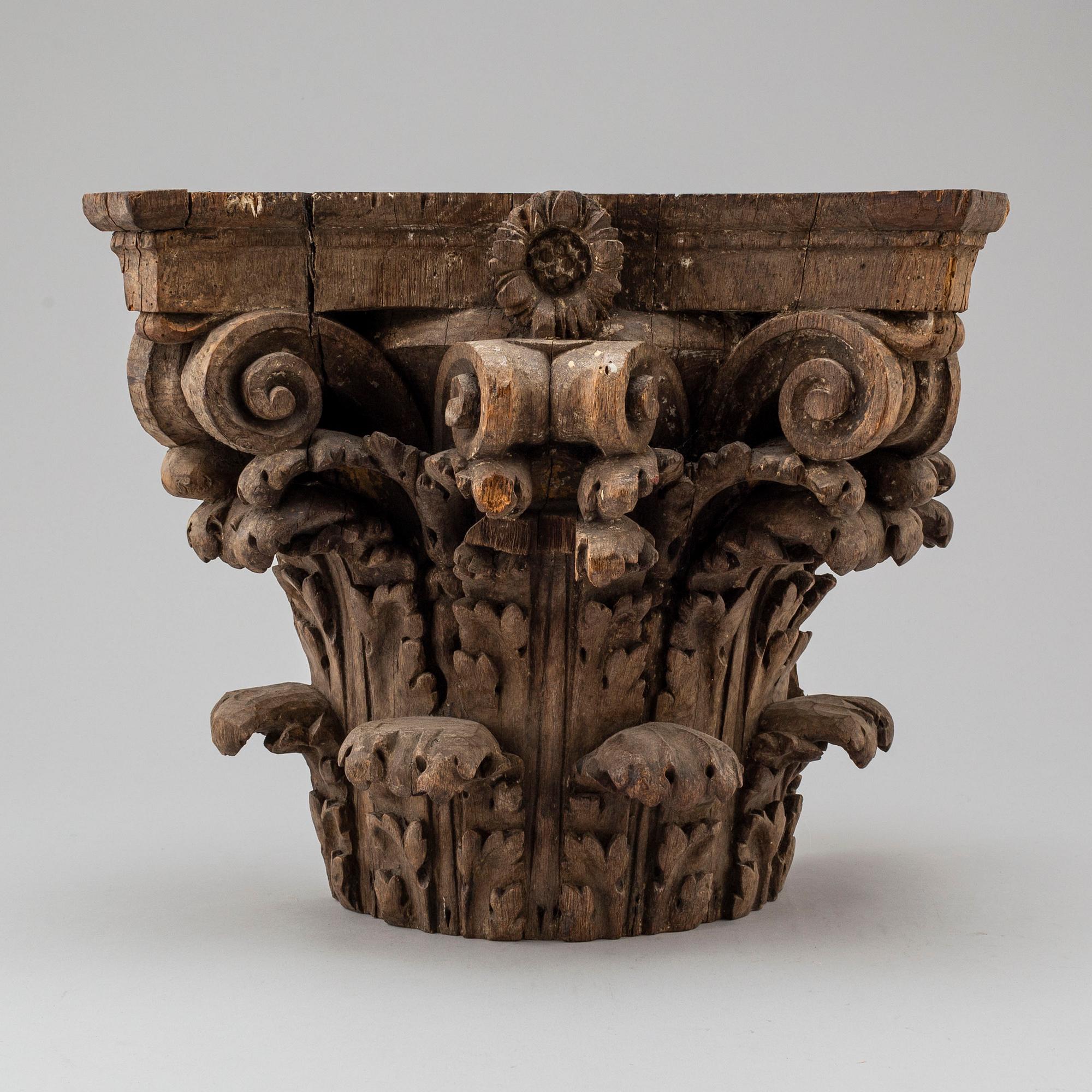 An 18th century carved wood corinthian capital.
