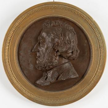 A painted and bronzed plaster portrait. Signed and dated Sven Andersson 1887.