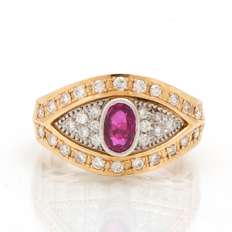 An 18K gold and platinum ring with diamonds and a ruby.