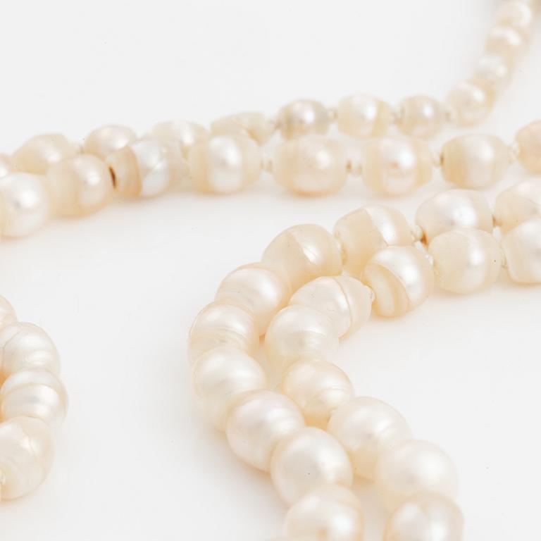 A two strand natural pearl necklace with a silver  clasp set with an old-cut diamond.