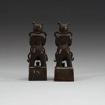 A pair of bronze joss stick holders, Qing dynasty.