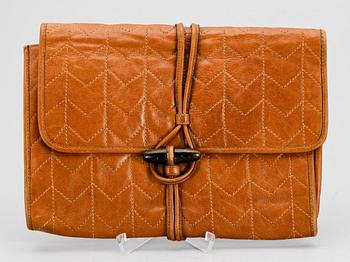 1265. A brown leather clutch from Yves Saint Laurent.
