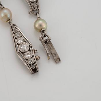 A platinum bracelet set with old-cut diamonds and pearls.