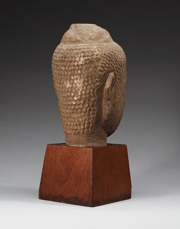 A large Lopbury type (later style) sandstone head of a Buddha, 17/18th Century.