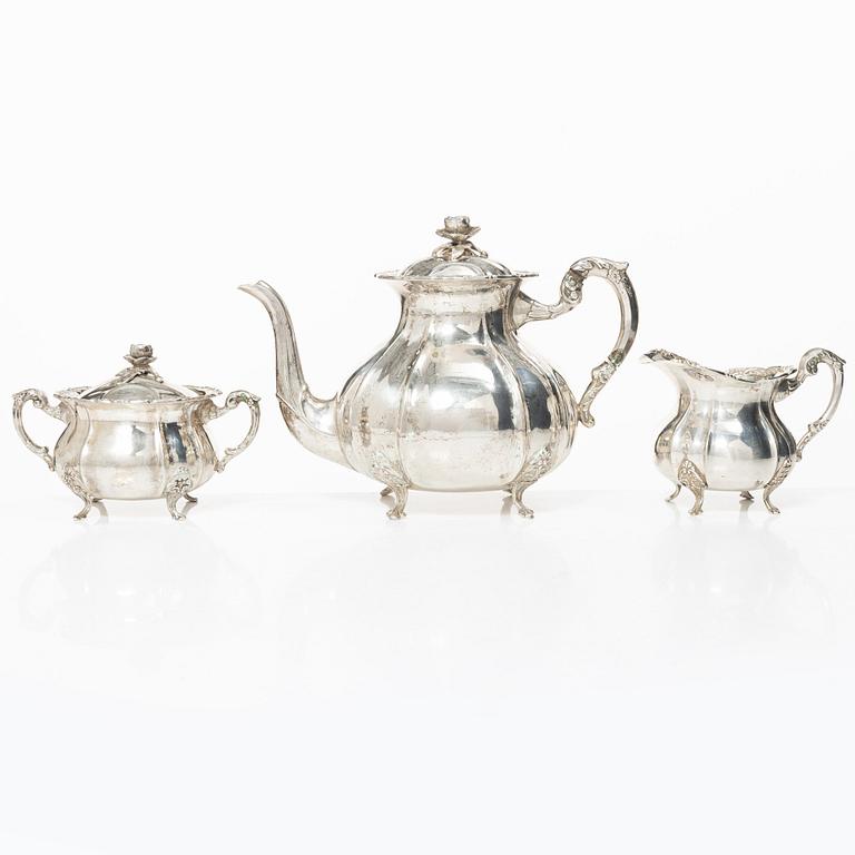 A Rococo style silver coffee pot, cream jug and sugar bowl, 20th century, Swedish import mark.