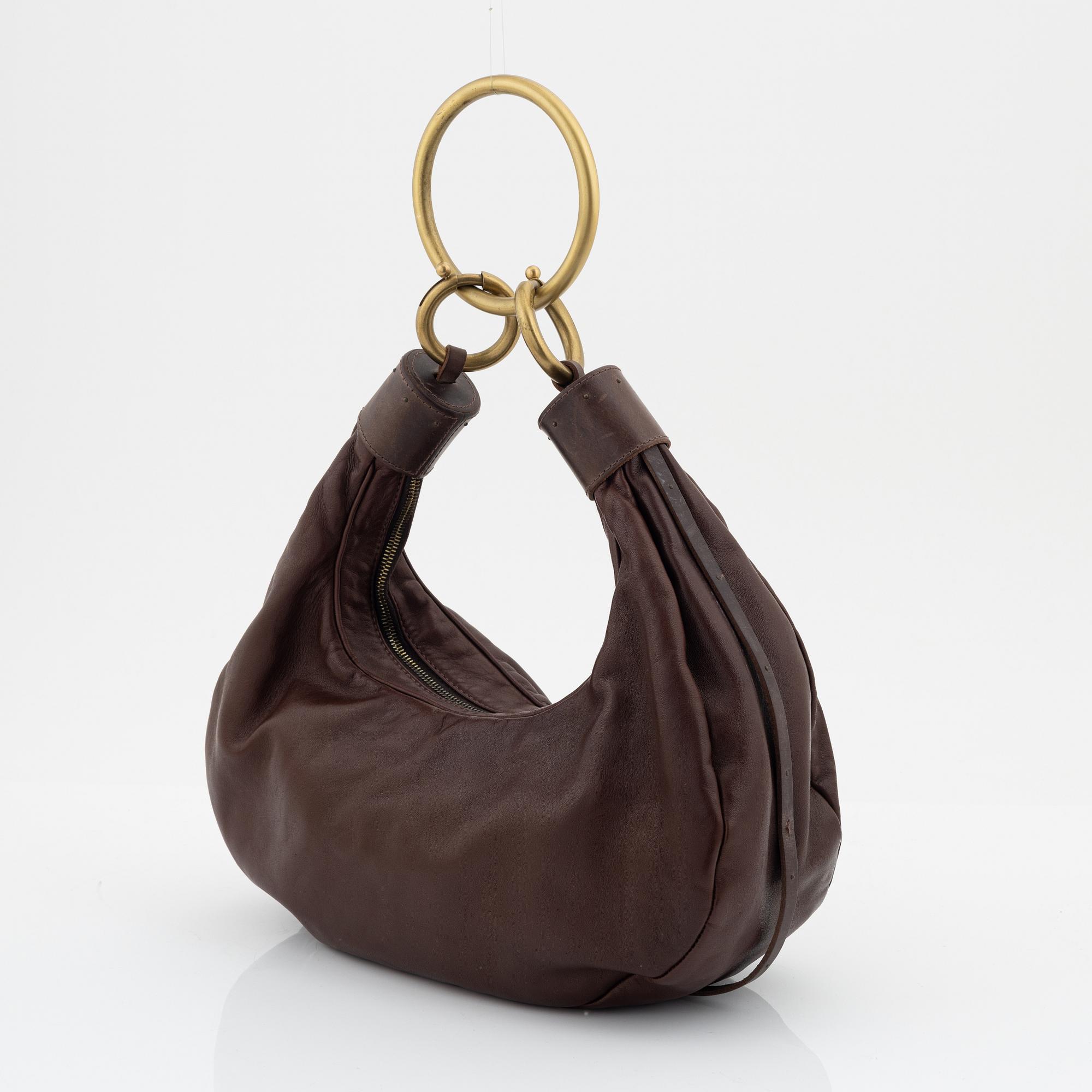 Chloé, a brown leather and brass bag.