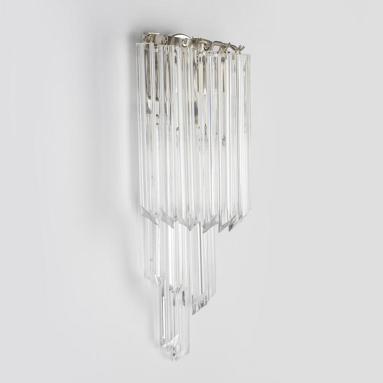 A pair of glass and metal wall lights.