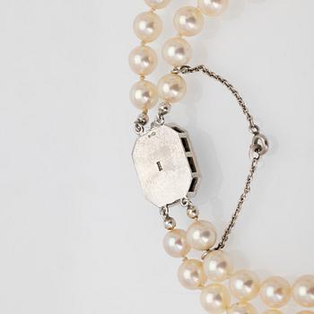 Two-row cultured pearl necklace with a silver and glass clasp.