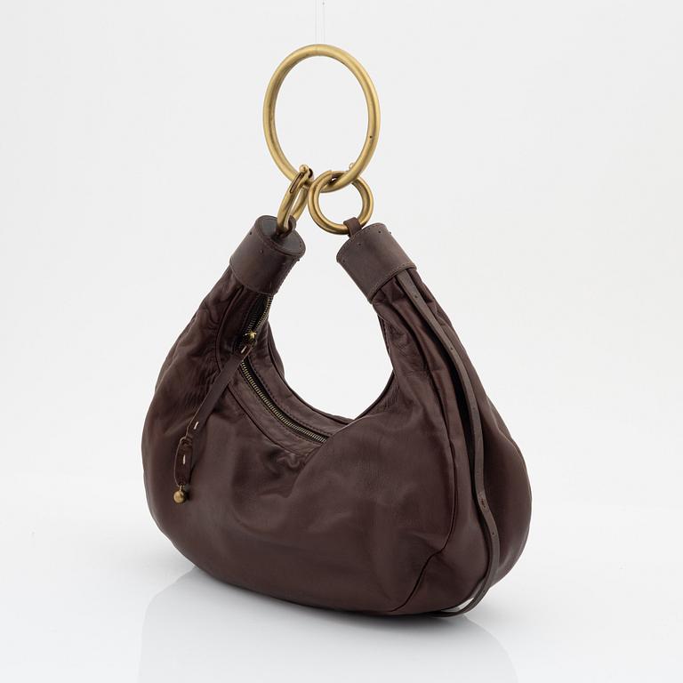 Chloé, a brown leather and brass bag.