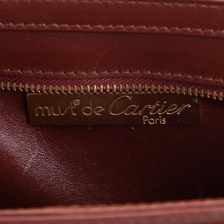 Must de Cartier bag clutch with accessories.