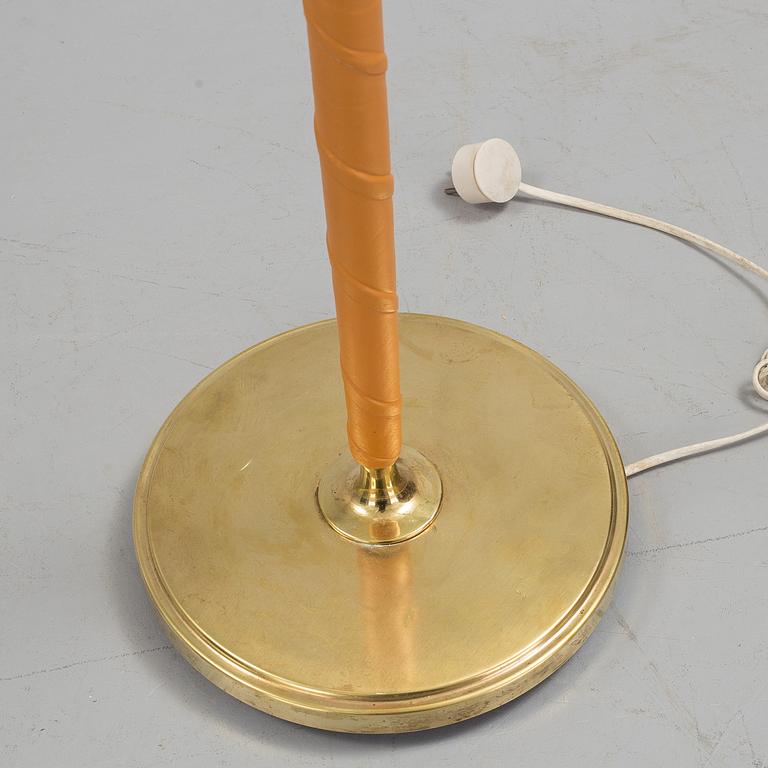 A 1960s brass and leather floor light.