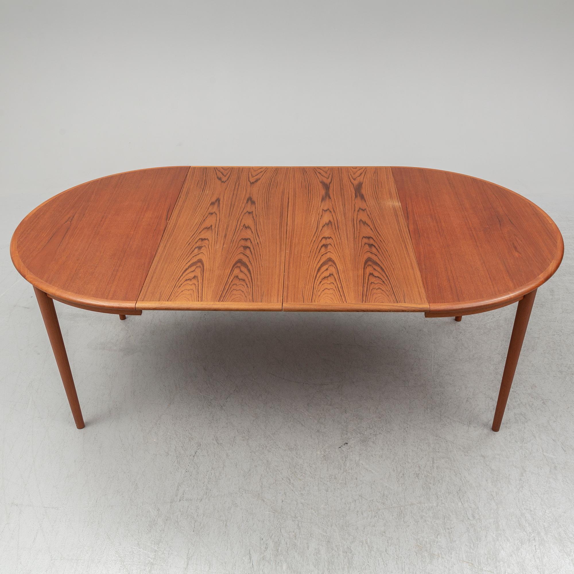 A 1960s teak veneered dining table.
