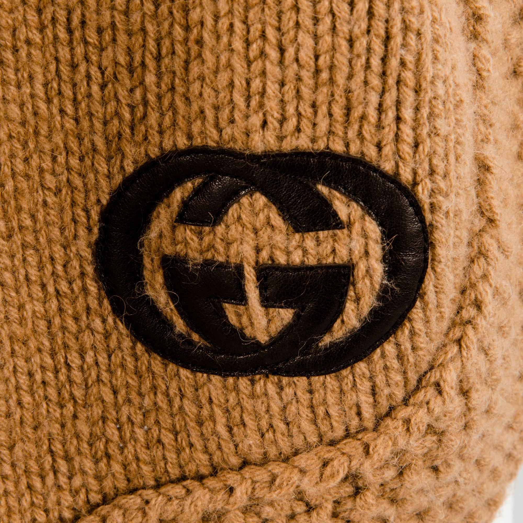 GUCCI, CAMEL HAIR PONCHO AND A HAT.