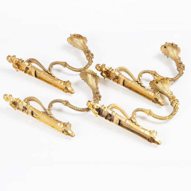 A set of four gilt bronze Louis XVI-style curtain holders, late 19th century.