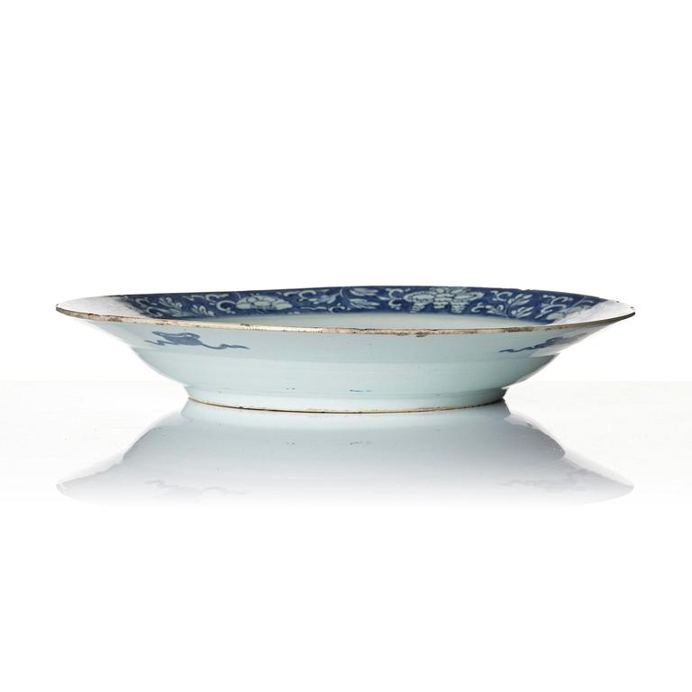 A blue and white 'reverse decorated' serving dish, Qing dynasty, Kangxi (1662-1722).