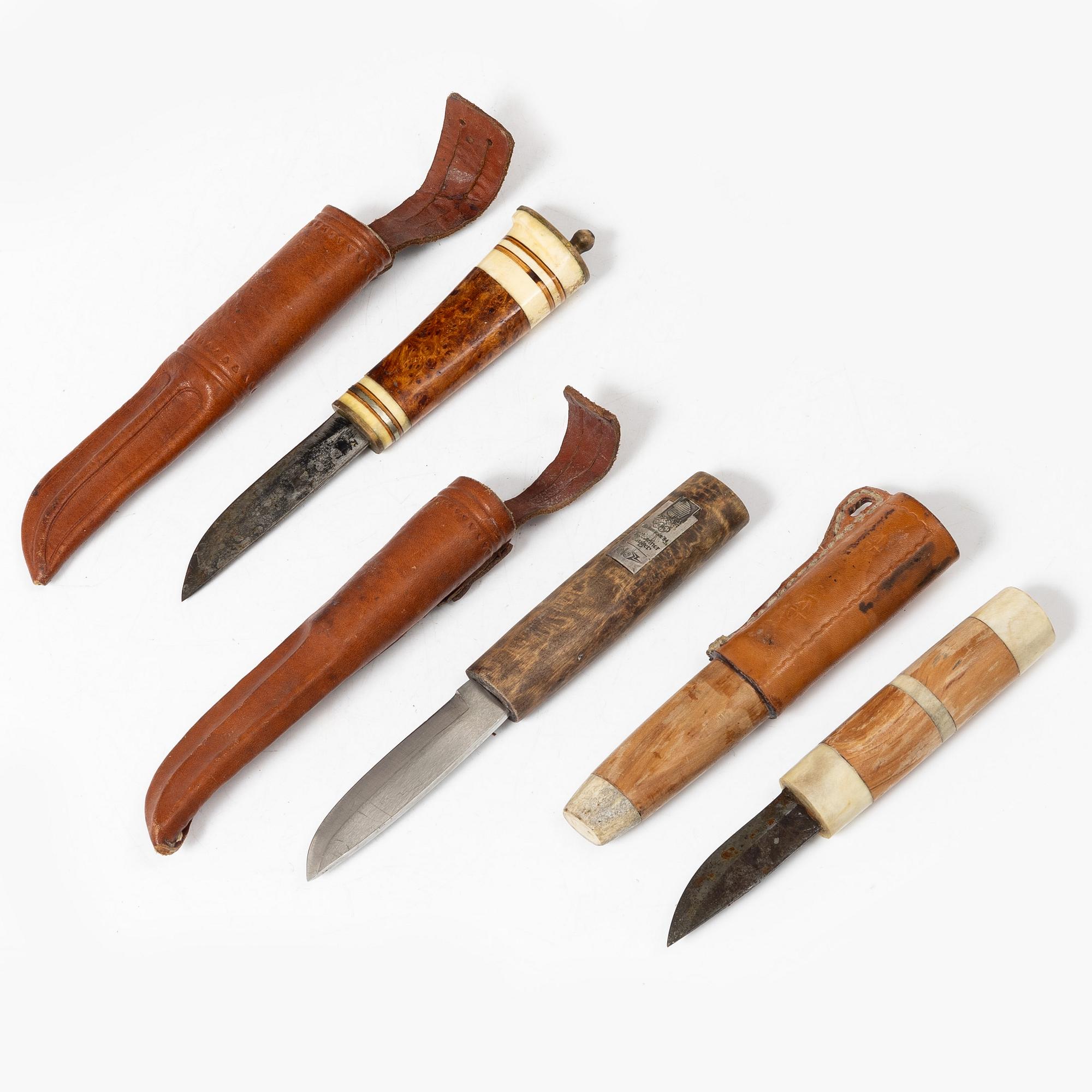 Six knives, and a cup.