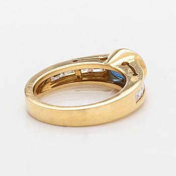 An 18K gold ring with an oval sapphire and baguette-cut diamonds. Finnish hallmarks, year 2000.